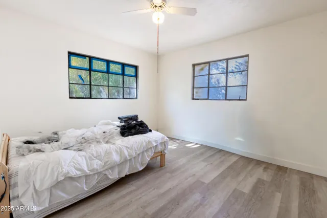 a bedroom with a bed and a window