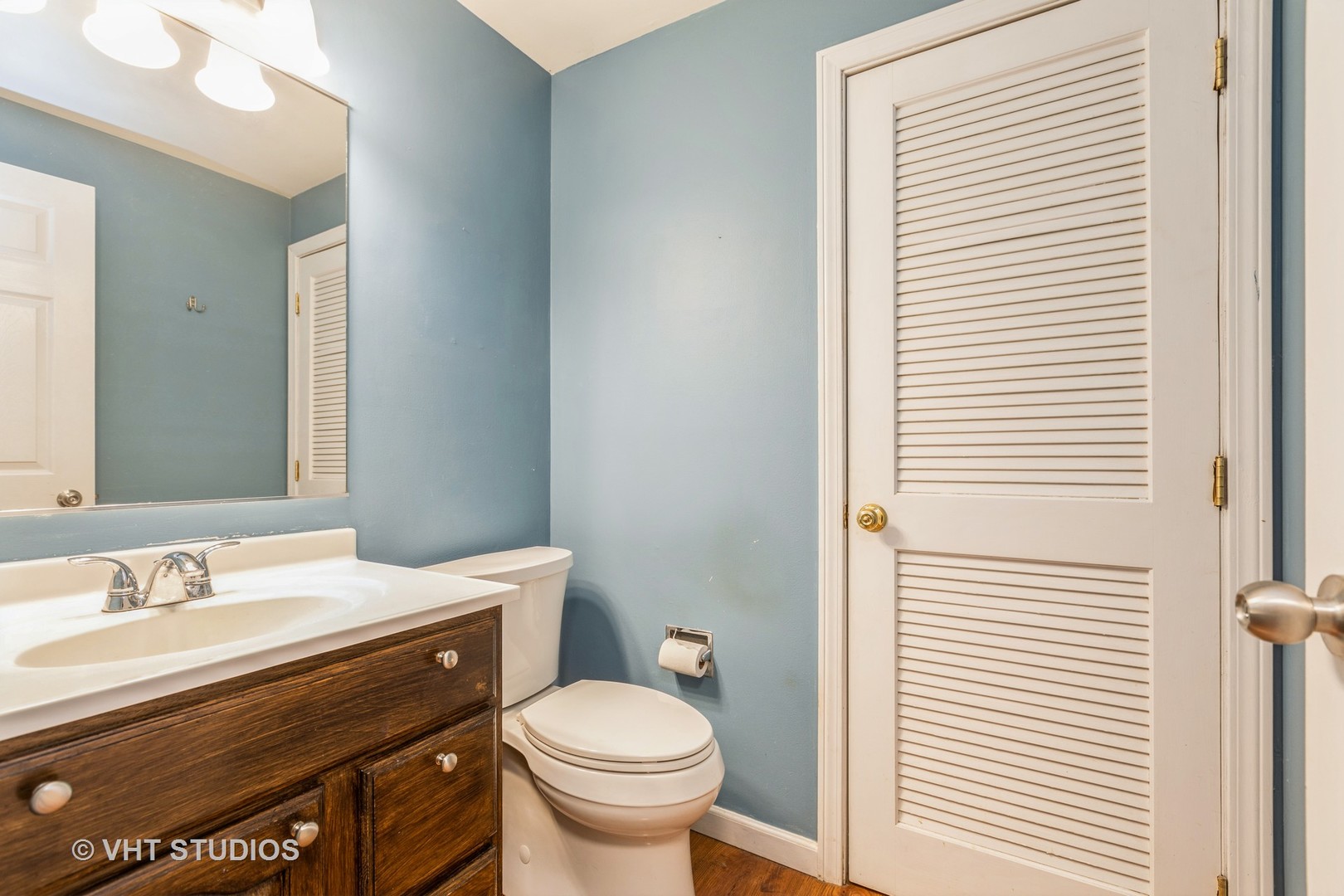 54 Oak Valley Drive Cary, IL 60013 - Photo 7 of 17 a bathroom with a sink a toilet and a mirror