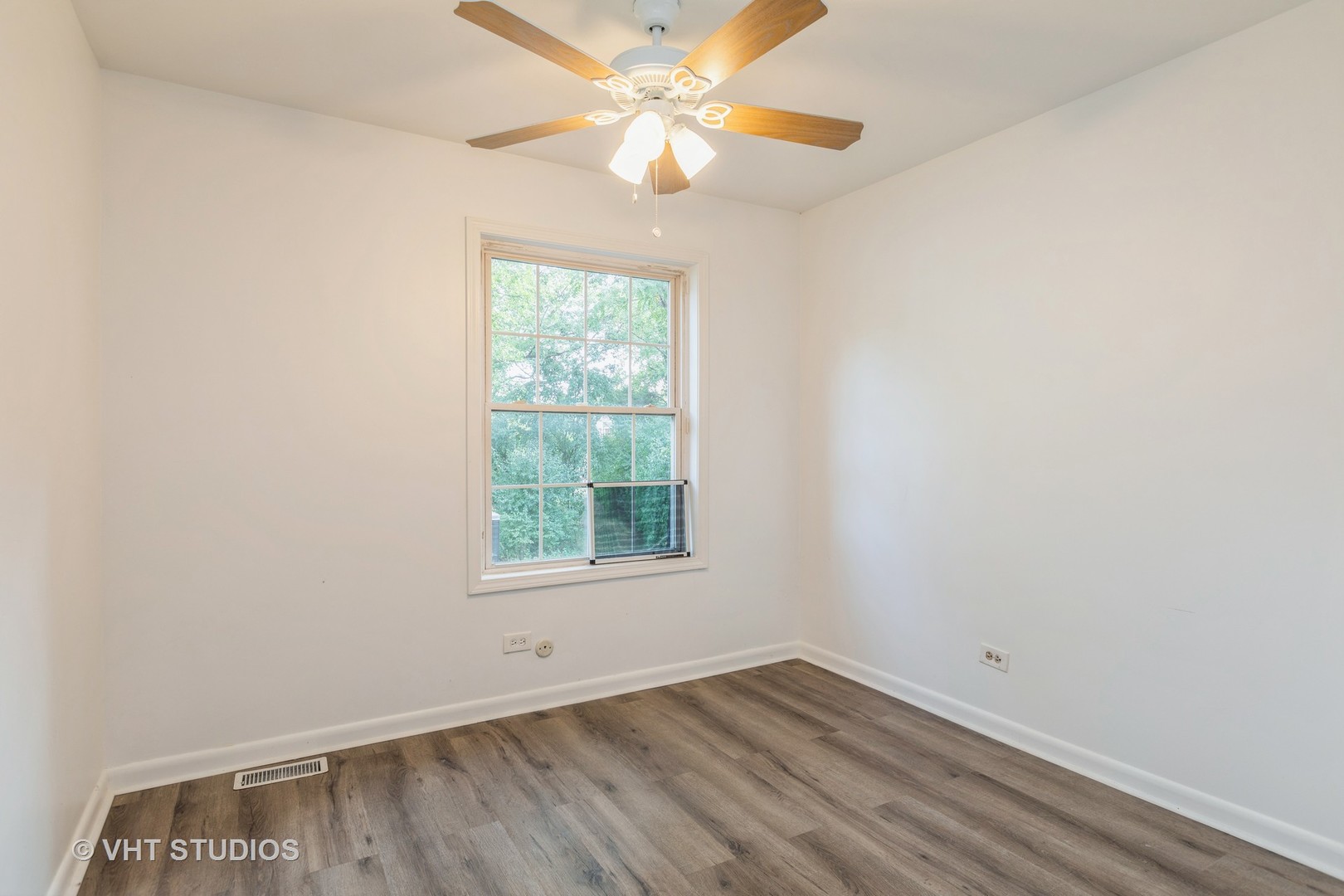 54 Oak Valley Drive Cary, IL 60013 - Photo 9 of 17 an empty room with a window and a fan