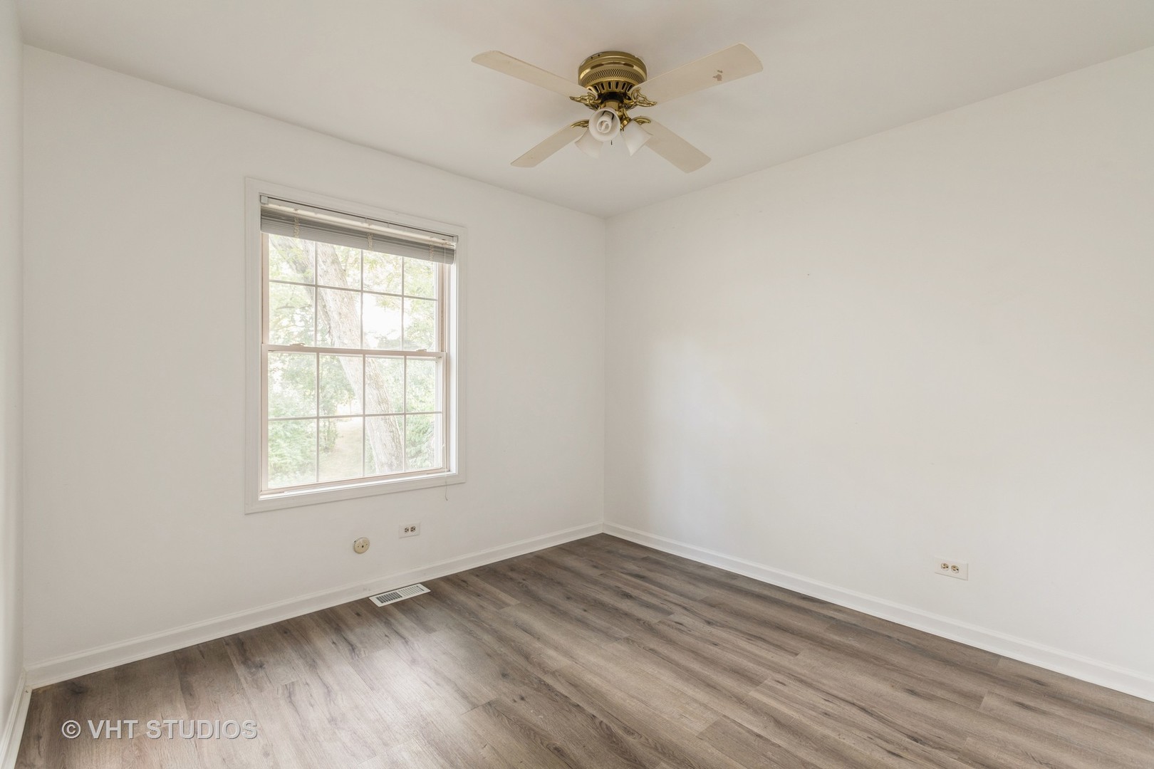 54 Oak Valley Drive Cary, IL 60013 - Photo 10 of 17 an empty room with a window and a ceiling fan