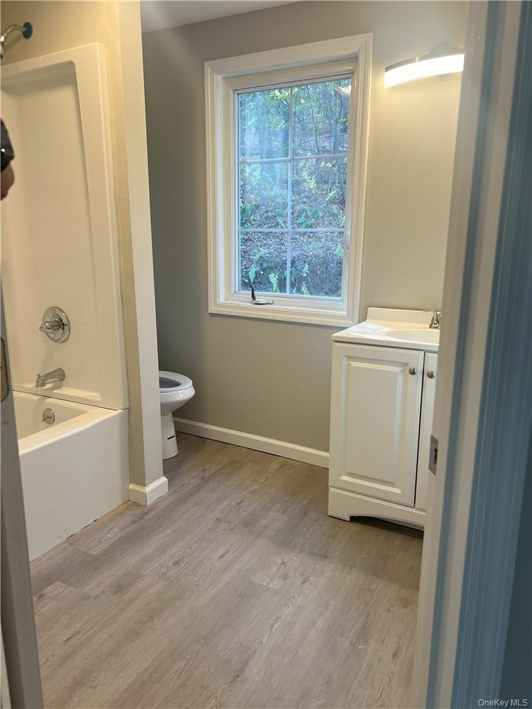 270 Benton Hollow Road Neversink, NY 12765 - Photo 16 of 21 a view of a bathroom with a bathtub and window