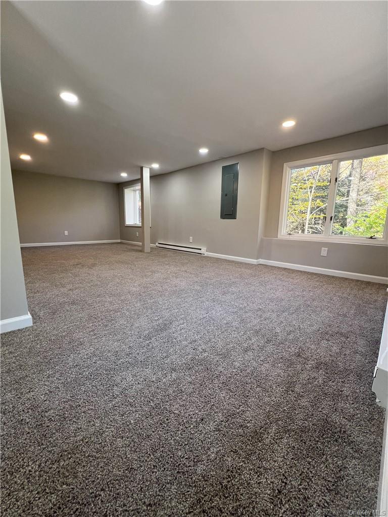 270 Benton Hollow Road Neversink, NY 12765 - Photo 7 of 21 an empty room with windows and refrigerator
