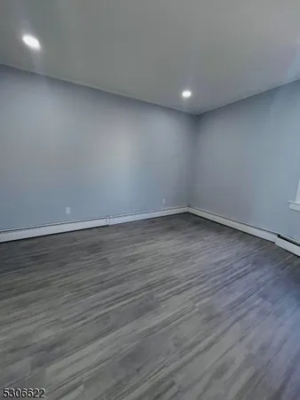 a view of room with wooden floor