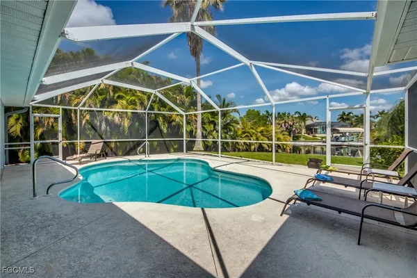 a swimming pool with outdoor seating and yard