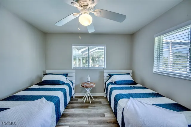 a bathroom with a granite countertop sink a toilet and a shower
