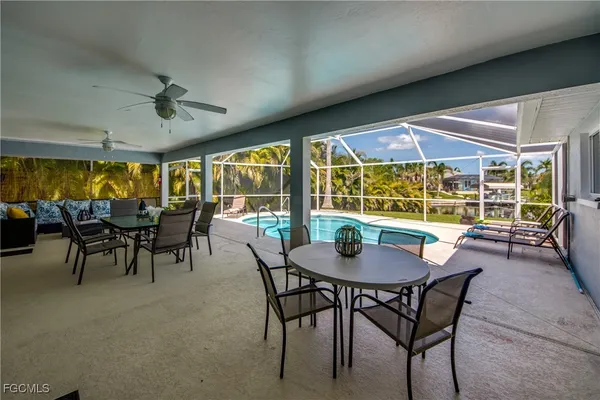 a dining room with furniture and a large window
