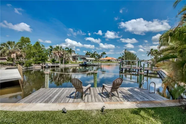 a view of a lake with a table and chairs