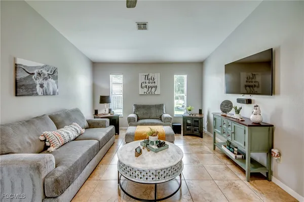 a living room with furniture and kitchen view