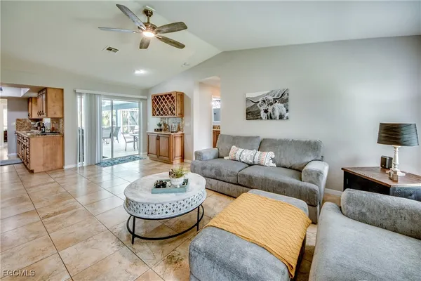 a dining room with furniture a chandelier and window