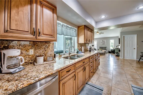 a kitchen with stainless steel appliances granite countertop counter space a sink and a refrigerator