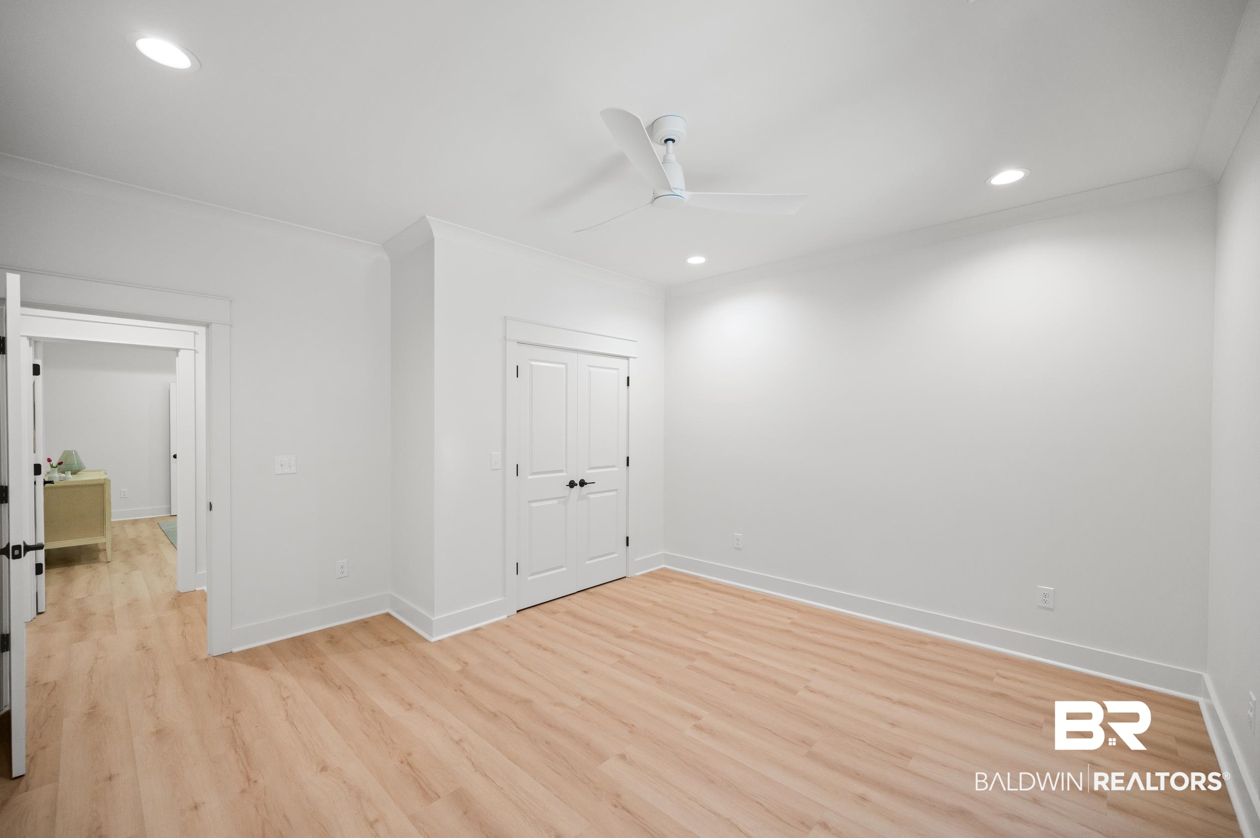 28889 Canal Road Orange Beach, AL 36561 - Photo 31 of 55 Empty room with light wood-type flooring, ceiling fan, and crown molding