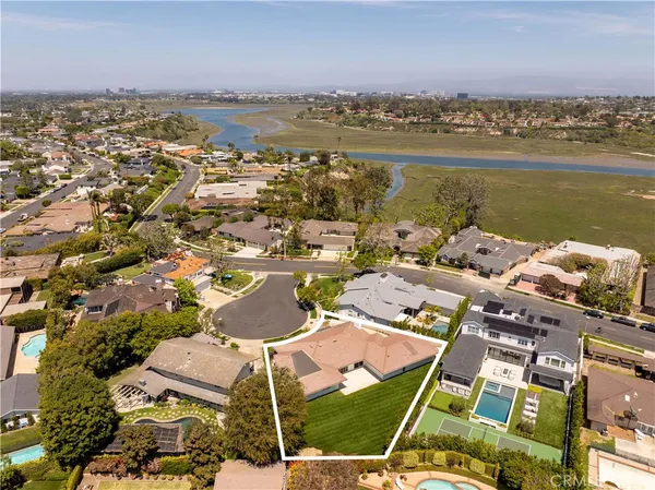 an aerial view of a residential building with outdoor space and ocean view