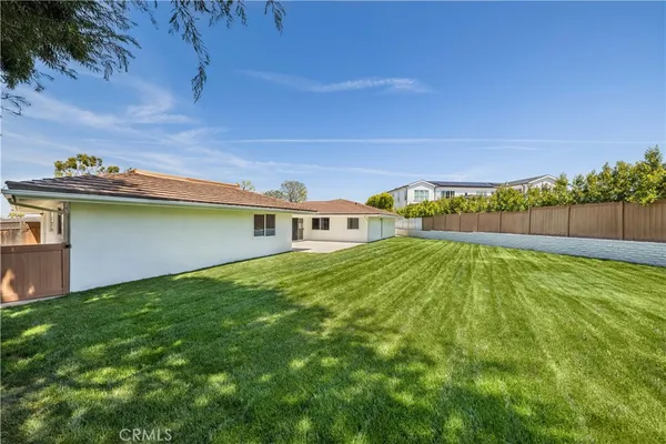 a view of a backyard with plants and a yard