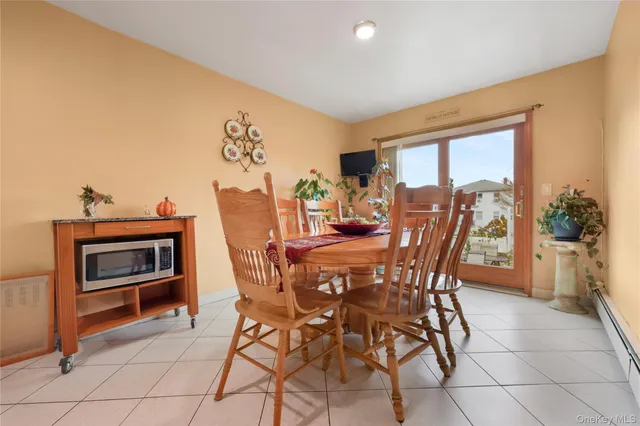 a view of a dining room with furniture and a window