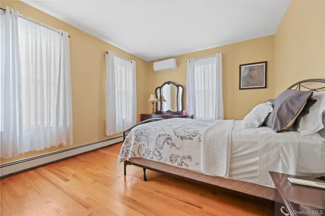 a bed sitting in a bedroom next to a window