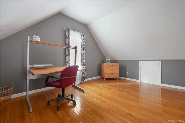 a view of a workspace with furniture and wooden floor