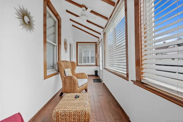 a balcony view with a chair and a potted plant