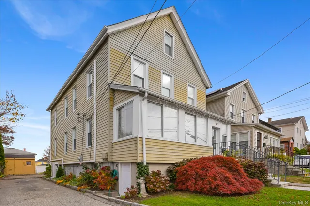 a front view of a house with a garden