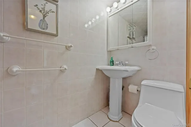 a bathroom with a sink toilet and a mirror