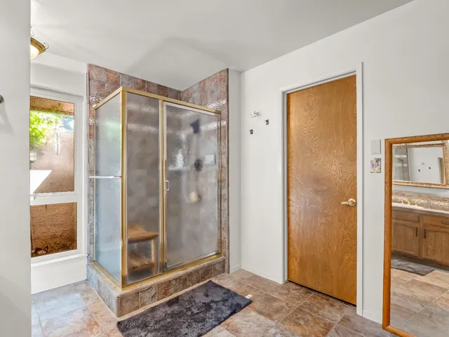 an empty room with a window and a fan