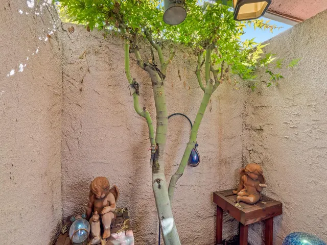 an empty room with window and a ceiling fan