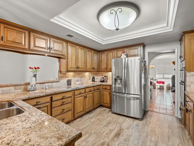 a kitchen with wooden cabinets and a stove top oven