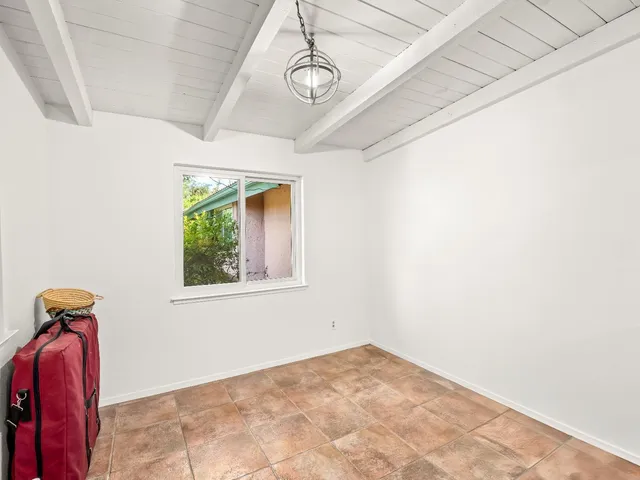 a kitchen with stainless steel appliances granite countertop a refrigerator a stove a sink dishwasher and wooden cabinets with wooden floor