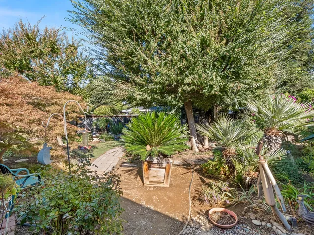 a backyard of a house with a yard and outdoor seating
