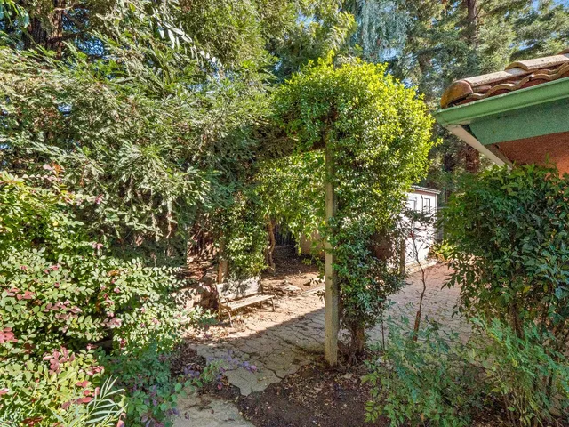 a backyard of a house with table and chairs