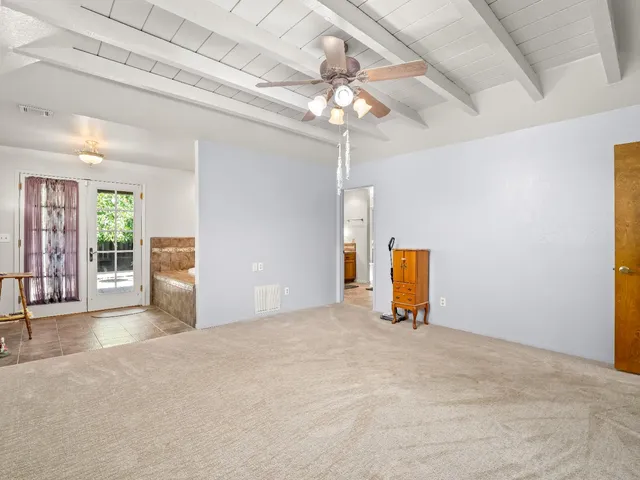 a bathroom with a granite countertop sink a toilet a mirror and shower