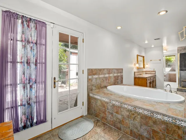 a large tub sitting in a bathroom