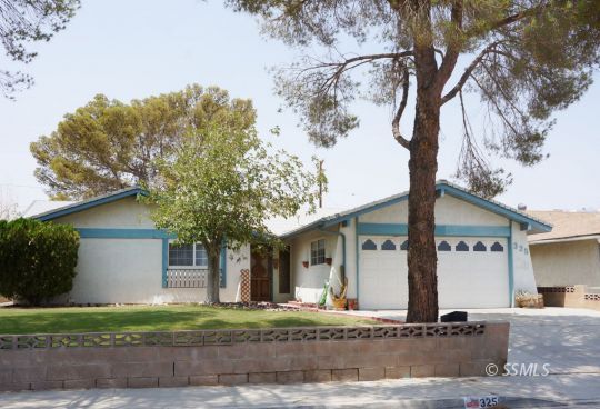 325 Traci Lane Ridgecrest, CA 93555 - Photo 1 of 13 a front view of a house with a yard and garage