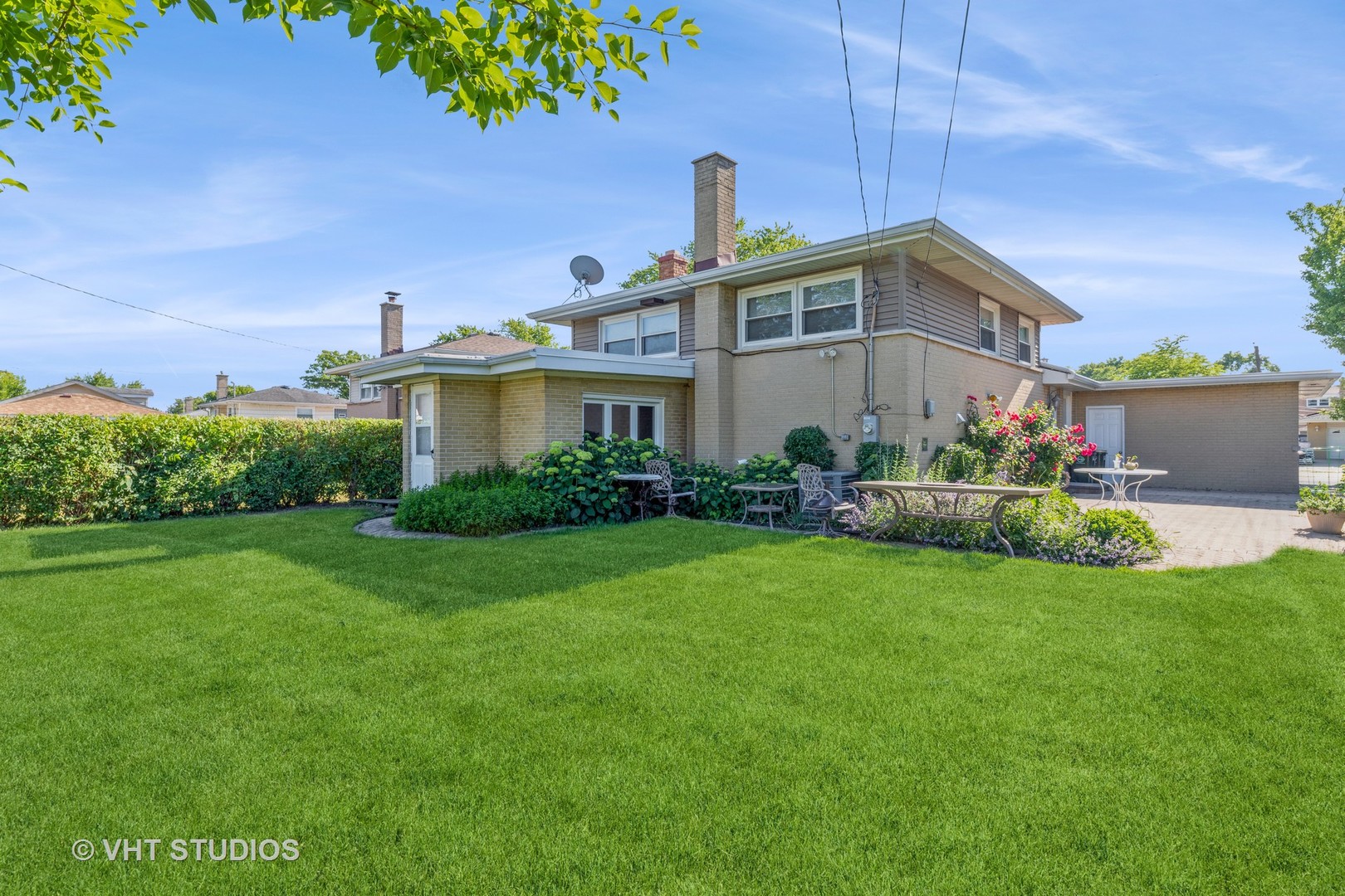 Undisclosed Address Niles, IL 60714 - Photo 16 of 17 a front view of a house with a yard and potted plants