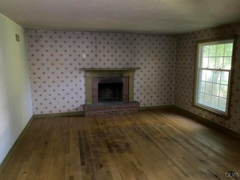 1029 Westgate Circle Bethlehem, PA 18017 - Photo 12 of 42 a view of an empty room with wooden floor and a fireplace