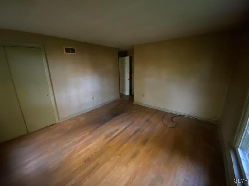 1029 Westgate Circle Bethlehem, PA 18017 - Photo 31 of 42 an empty room with wooden floor and windows