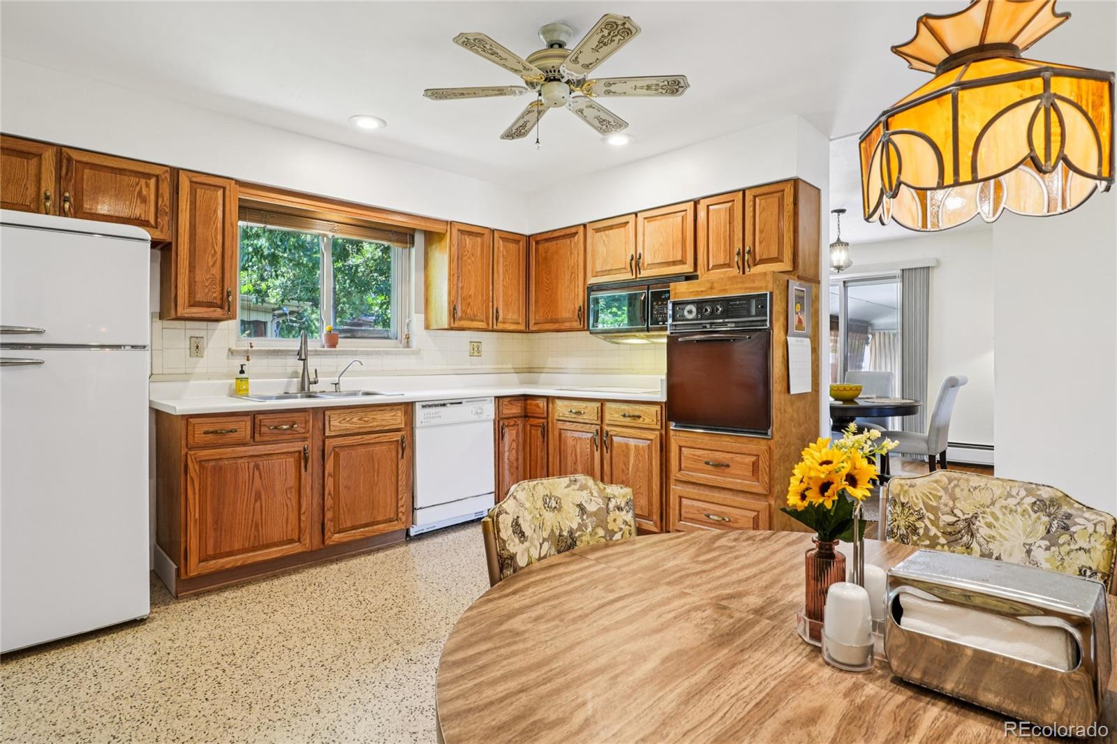 6920 West 47th Place Wheat Ridge, CO 80033 - Photo 12 of 43 a bedroom with a bed and dresser with mirror