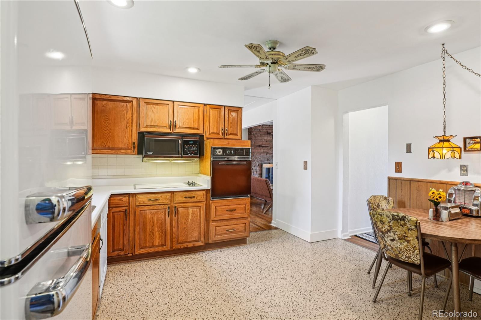 6920 West 47th Place Wheat Ridge, CO 80033 - Photo 13 of 43 a kitchen with stainless steel appliances granite countertop a sink and cabinets