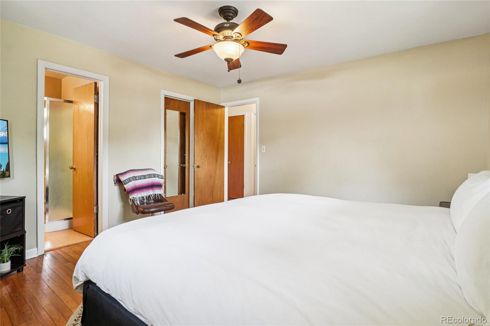 6920 West 47th Place Wheat Ridge, CO 80033 - Photo 16 of 43 a bedroom with a bed and a chandelier