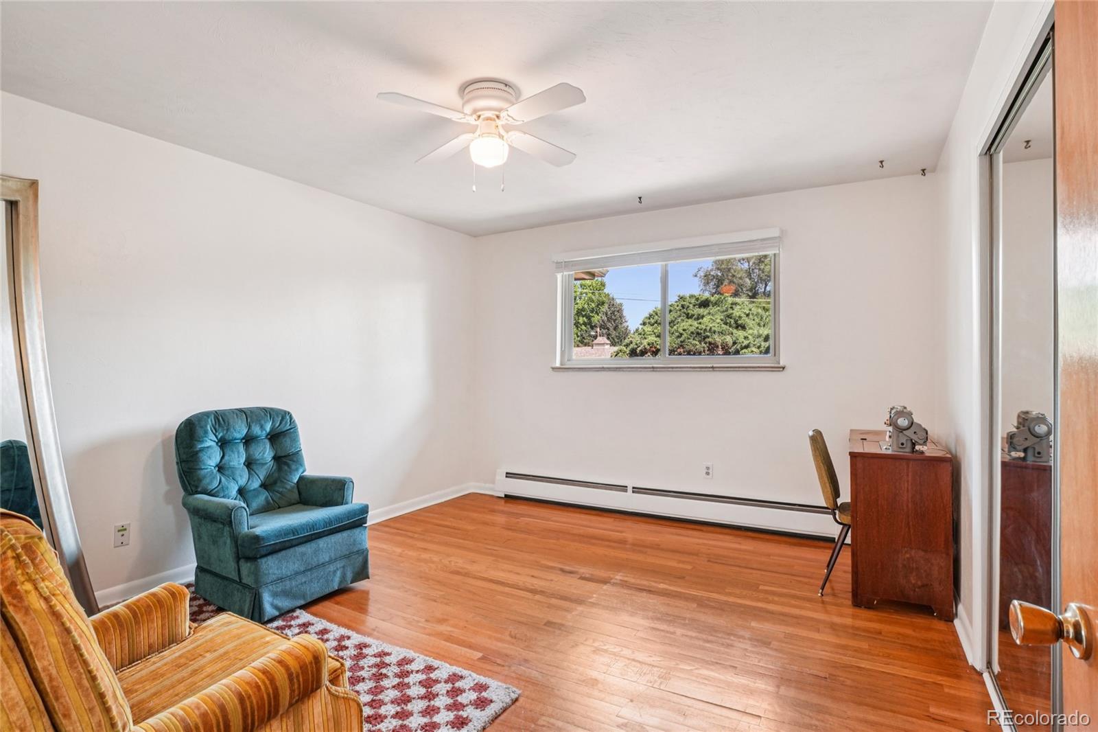 6920 West 47th Place Wheat Ridge, CO 80033 - Photo 18 of 43 a living room with furniture and a chandelier