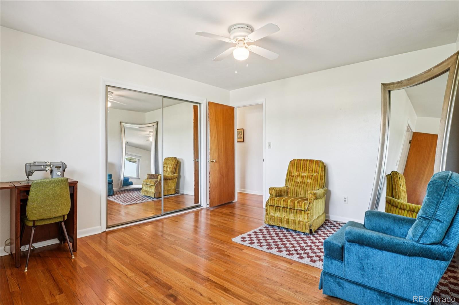 6920 West 47th Place Wheat Ridge, CO 80033 - Photo 19 of 43 a living room with furniture and a wooden floor
