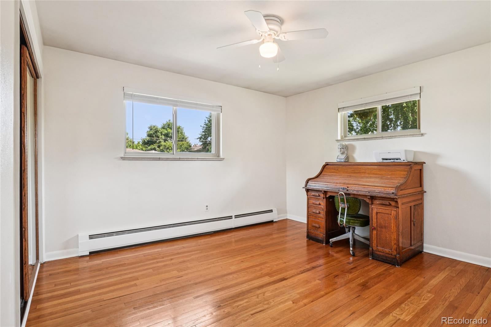 6920 West 47th Place Wheat Ridge, CO 80033 - Photo 21 of 43 a view of room with furniture wooden floor and window