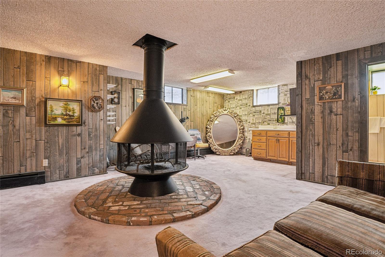 6920 West 47th Place Wheat Ridge, CO 80033 - Photo 24 of 43 a living room with furniture and a chandelier