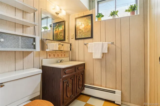 a bathroom with a sink toilet vanity and shower