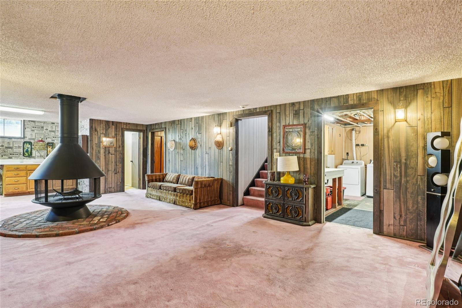 6920 West 47th Place Wheat Ridge, CO 80033 - Photo 33 of 43 a view of a livingroom with furniture and a flat screen tv