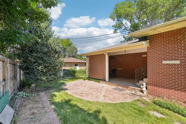 a view of a porch with chairs and backyard