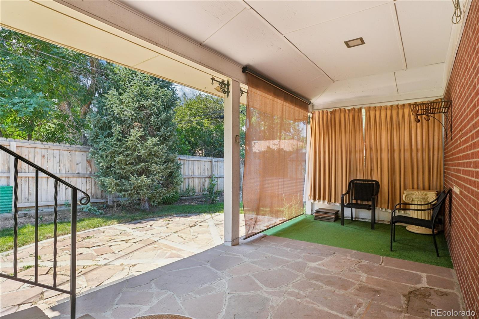 6920 West 47th Place Wheat Ridge, CO 80033 - Photo 40 of 43 a view of a porch with chairs and backyard