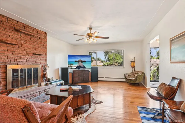 a living room with furniture a fireplace and a table