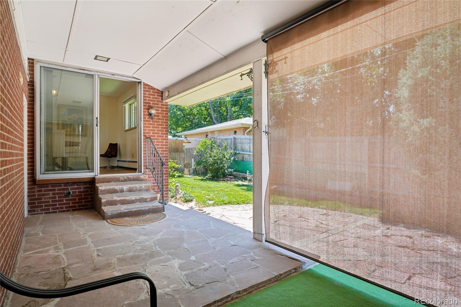 6920 West 47th Place Wheat Ridge, CO 80033 - Photo 41 of 43 a front view of a house with a garden