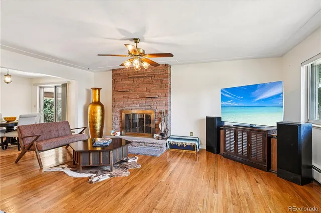 a view of a livingroom with furniture a dinning room and stairs