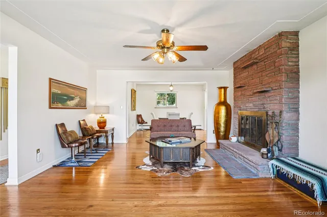 a living room with fireplace furniture and a wooden floor